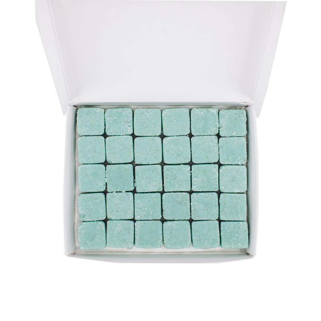30 waterless, biodegradable, natural, dissolvable body wash cubes in an open recyclable box. The tablets are blue and the box is white.
