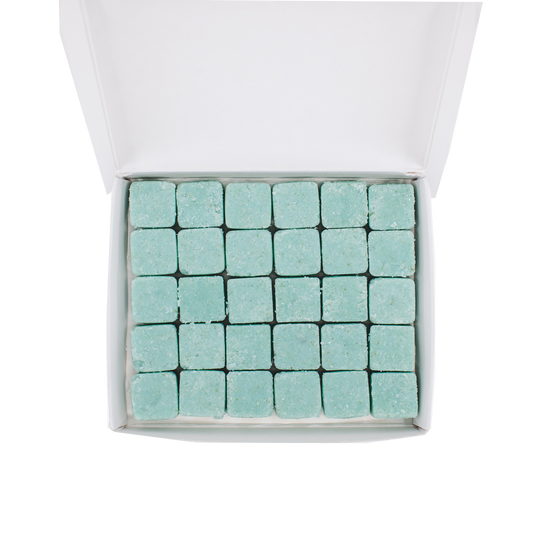 30 waterless, biodegradable, natural, dissolvable body wash cubes in an open recyclable box. The tablets are blue and the box is white.