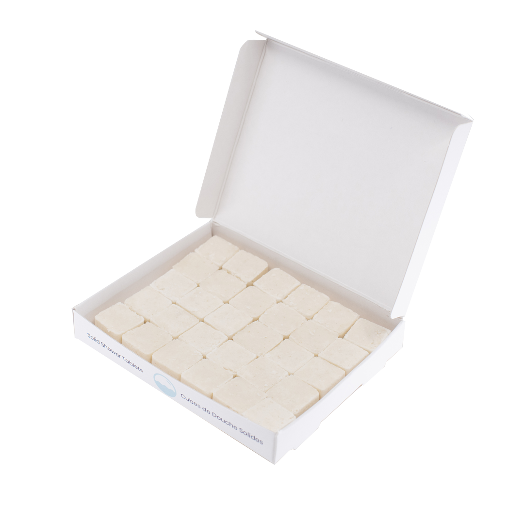 30 waterless, biodegradable, natural, dissolvable shampoo cubes in an open recyclable box. The tablets are white and the box is white.