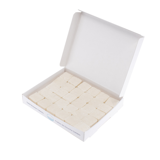 30 waterless, biodegradable, natural, dissolvable shampoo cubes in an open recyclable box. The tablets are white and the box is white.