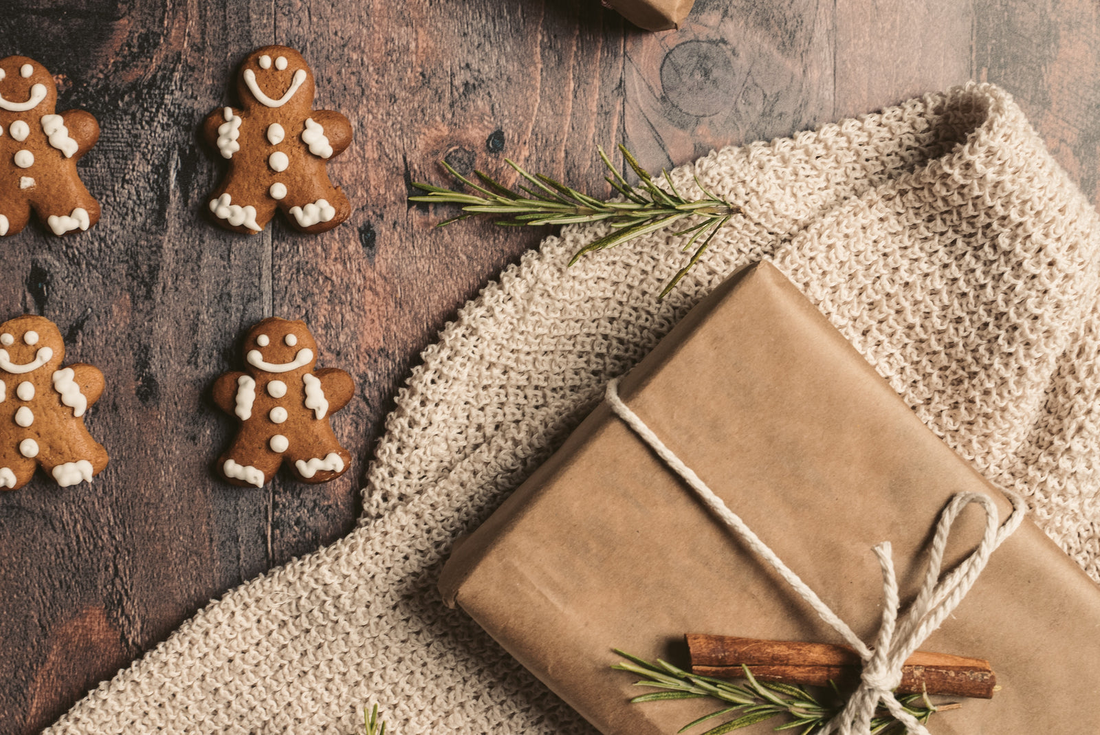 Sustainably wrapped EarthSuds waterless shampoo gift with gingerbread and pine needles around it