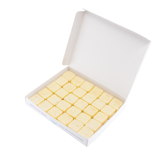 30 waterless, biodegradable, natural, dissolvable conditioner cubes in an open recyclable box. The tablets are yellow and the box is white.
