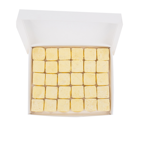 30 waterless, biodegradable, natural, dissolvable conditioner cubes in an open recyclable box. The tablets are yellow and the box is white.