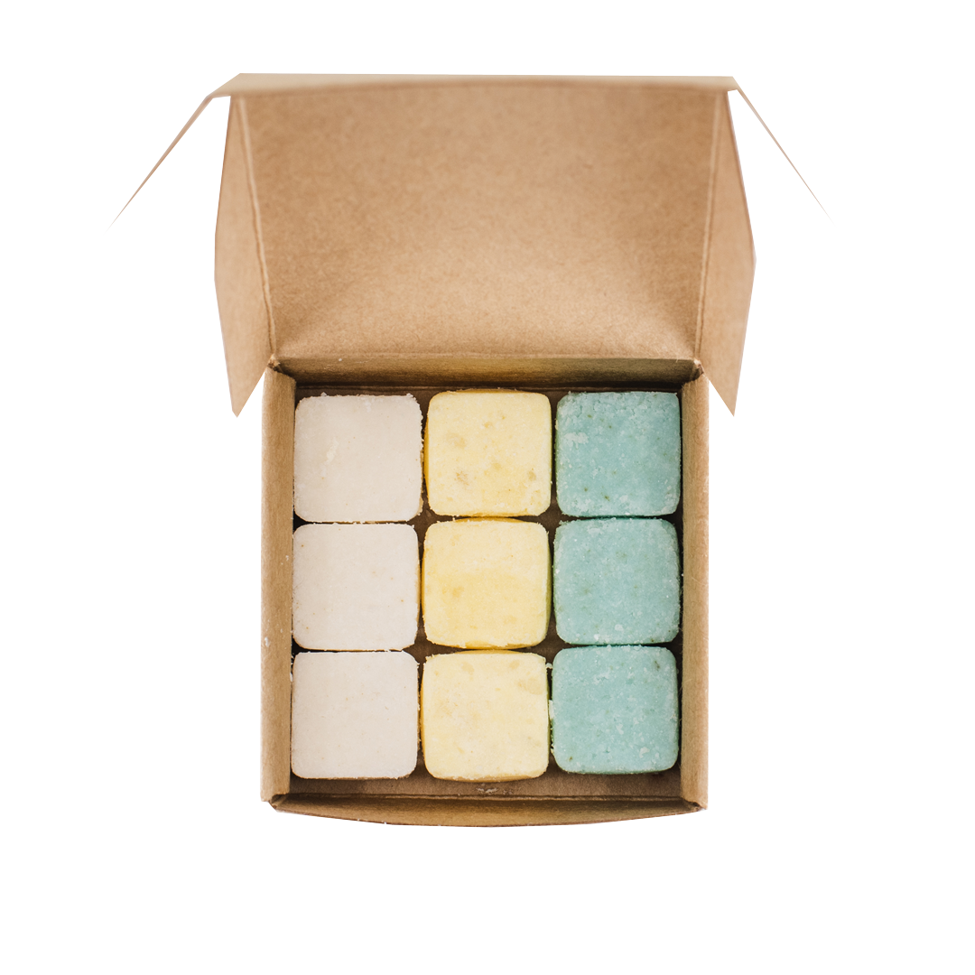 Dissolvable tablets of shampoo, conditioner, body wash in recyclable paper box for hotels, Airbnbs, and bed & breakfast accommodations.